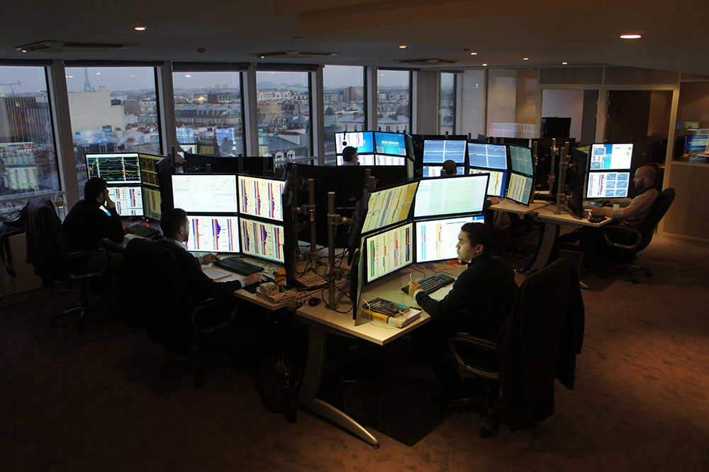Currency Traders at their work stations, representing the trading competition