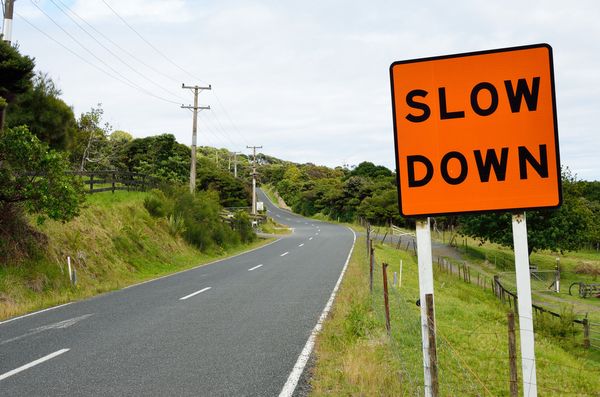 Image of the slow down sign representing solid forex trading tips.