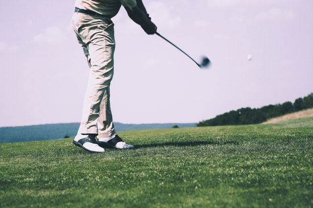 Image of a swinging golfer representing the part time trading league. 