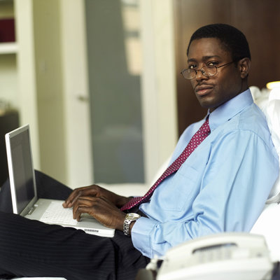 image of an afro-american man with the laptop working on his hedge fund career path