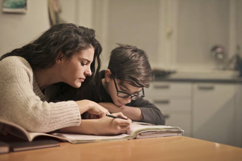 image of a mother, teaching her son how to trade spot gold and silver in the kitchen