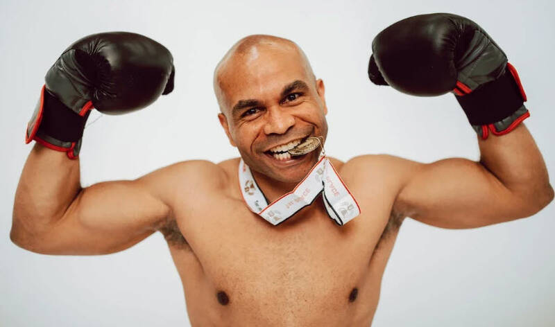 image of a boxer that have won the medal, describing the forex trading psychology tips, as to how winning in sports are the same as winning in the forex market